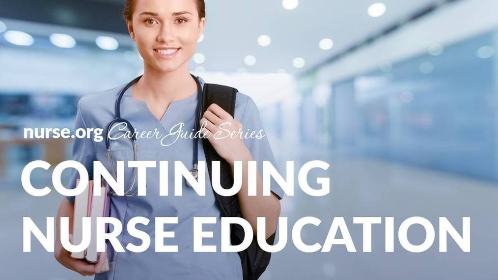 Student holding books wearing scrubs studying to become a nurse