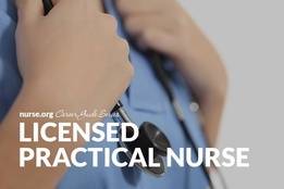 Confident nurse wearing scrubs holding onto stethoscope